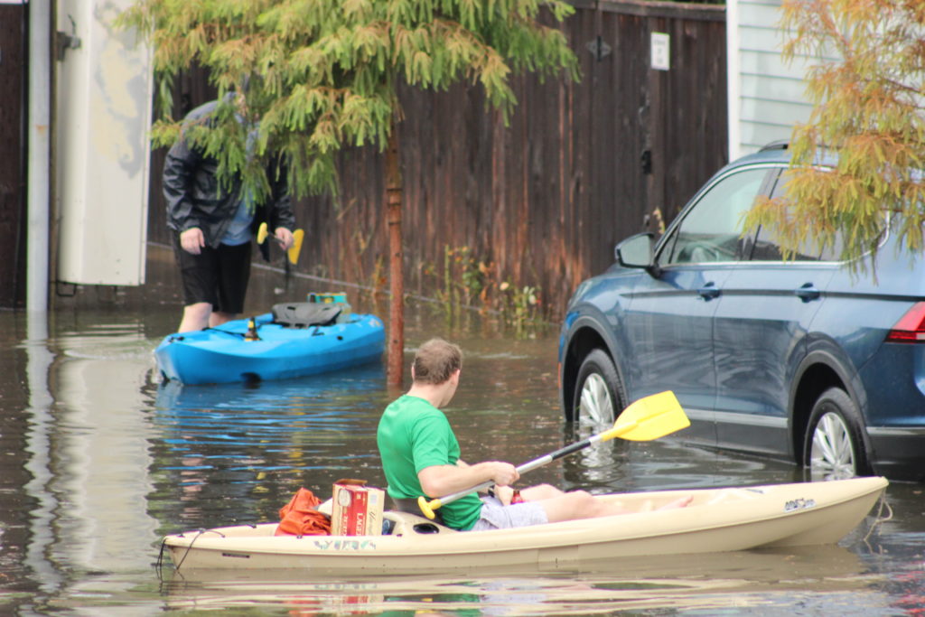 Canoeing down the street with a 12-pack on-hand.