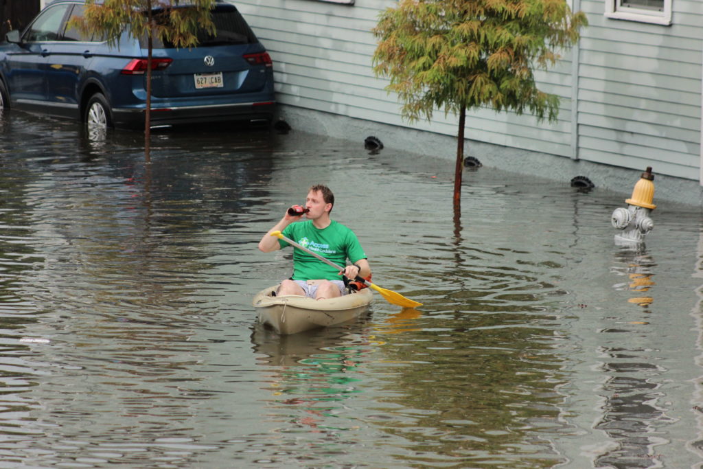 Canoeing down the street with a 12-pack on-hand.